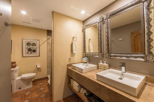 a bathroom with two sinks and a toilet at A Sunset Chateau in Sedona