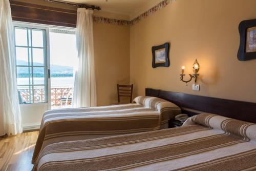 Postel nebo postele na pokoji v ubytování Hotel El Molino