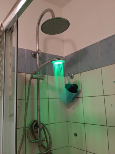 a shower in a bathroom with a light on the wall at B&B Casa Valeria in Catania