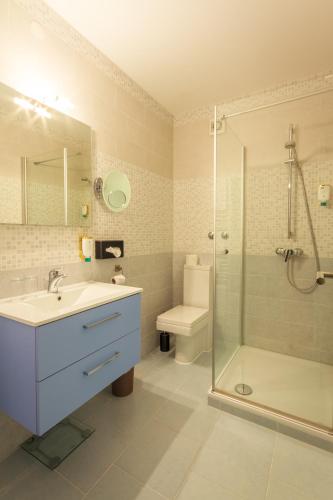 a bathroom with a sink and a shower and a toilet at Schwarzwaldhotel Sonne in Baden-Baden