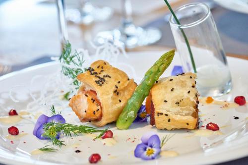 a white plate with food on a table at Hotel Restaurant Rathaus in Thun