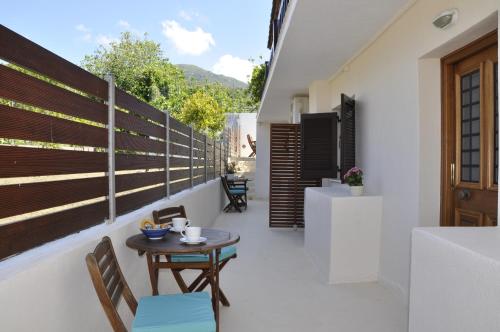 a patio with a table and chairs on a balcony at Ava Apartments in Agios Gordios