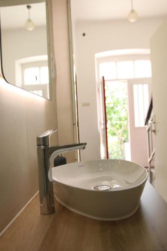 a bathroom with a white sink and a mirror at Central House Nona in Crikvenica