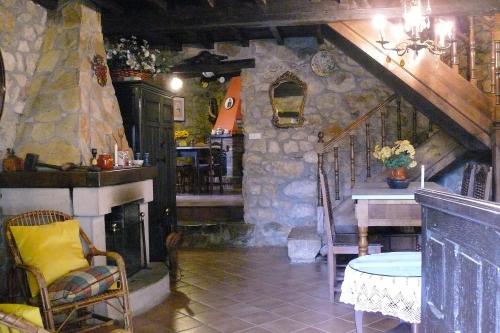 a room with a fireplace and a table in a house at La Casina de Celorio in Celorio