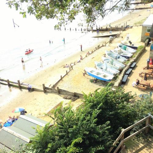 a beach with a bunch of people in the water at Villa Mentone Hotel in Shanklin
