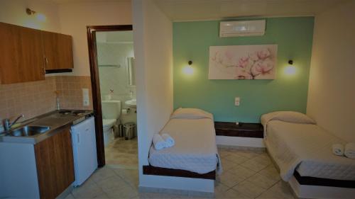 a room with a bathroom with a sink and a bed at Doras Zante Studios & Apartments in Argassi