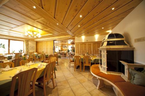 a restaurant with tables and chairs and a fireplace at Landgasthof Paradies in Frickingen