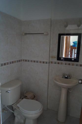 a bathroom with a toilet and a sink at Condominio Punta Bolivar in San Antero