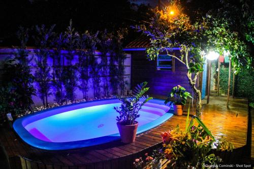 a swimming pool in a backyard at night at Venere - Bed and Breakfast in Florianópolis
