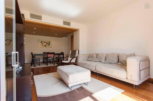 a living room with a couch and a table at Apartamento Expo in Lisbon