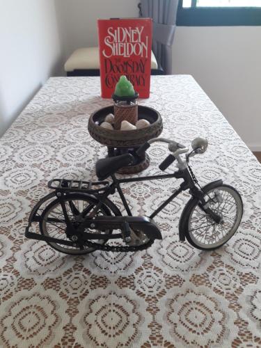 a toy bike sitting on a table next to a book at New Loft Modern Home in Hang Dong