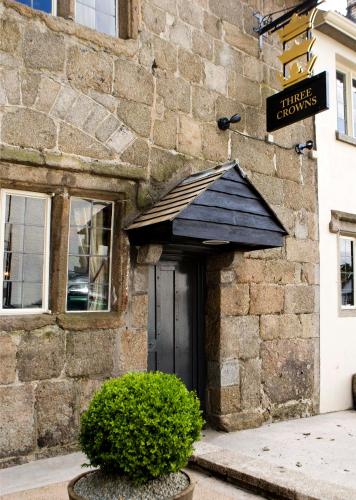 a entrance to a building with a black door at The Three Crowns in Chagford