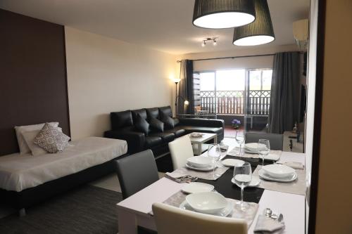 a living room with a table and a couch at RochaBay Apartment in Portimão