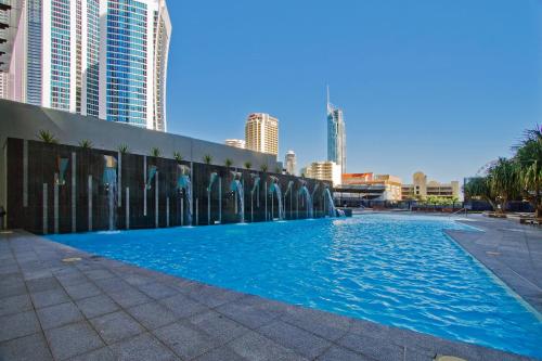 a large swimming pool in a city with tall buildings at Circle on Cavill - Gclr in Gold Coast