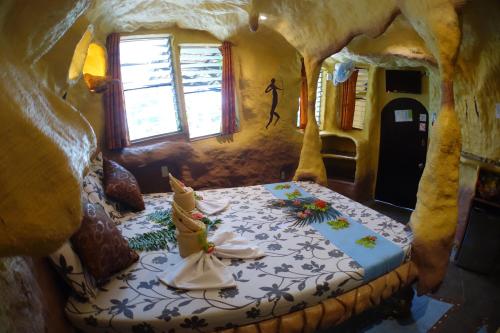 a bedroom with a bed in a cave style room at Takatuka Beach Resort in Sipalay