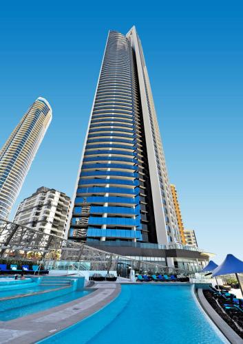 a tall building with a swimming pool in front of it at Soul Surfers Paradise - Gclr in Gold Coast