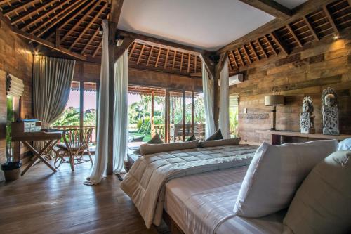 a bedroom with a large bed in a room at Marika Sawah Villa in Seminyak