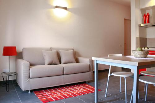 a living room with a couch and a table at Cascina nel Bosco in Cannobio