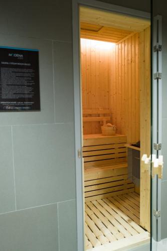 a sauna inside of a room with a door at Modena by Fraser Bangkok in Bangkok