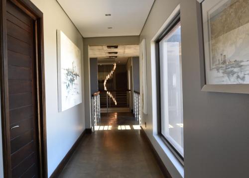 a hallway of a house with lights on the wall at Tredenham Boutique Hotel in Bloemfontein
