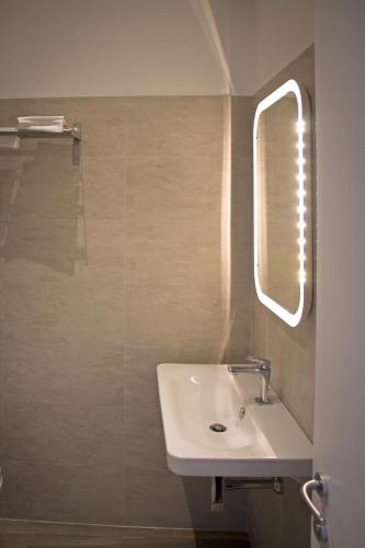 a bathroom with a sink and a mirror at Residence Fanny in Alassio