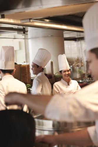 a group of chefs standing in a kitchen at Raffles Makati in Manila