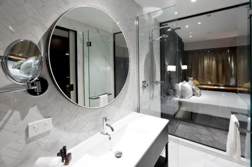 a bathroom with a sink and a mirror at Crowne Plaza Christchurch, an IHG Hotel in Christchurch