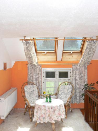 a room with a table and chairs and a window at Ferienhof Hiemer in Sulzberg