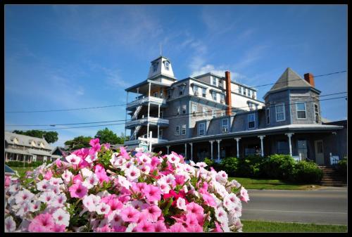 a large house with pink flowers in front of it at Summercamp in Oak Bluffs