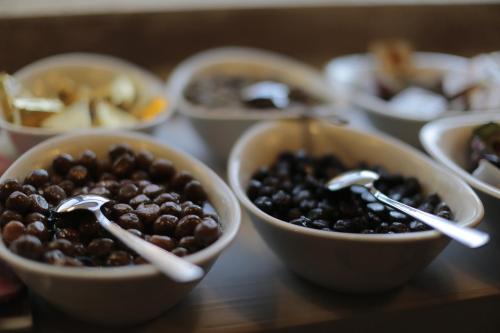a table topped with bowls of beans and spoons at Shoestring Cave House in Goreme