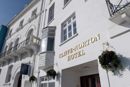 a white building with a hotel sign on it at Cliffe Norton in Tenby