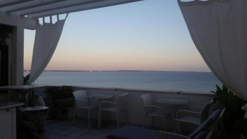 a balcony with chairs and a view of the ocean at B&B Punta Cutieri in Gallipoli