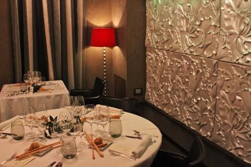 a dining room with two tables with white tableclothsurrencyangering at Hotel Tosco Romagnolo in Bagno di Romagna