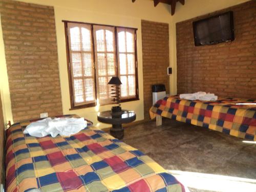 Ένα ή περισσότερα κρεβάτια σε δωμάτιο στο Complejo Mi Viejo Vicente