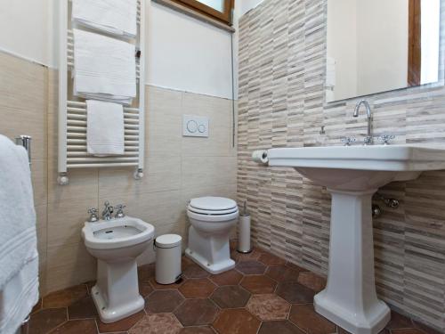 a bathroom with a sink and a toilet and a sink at Il Nido Del Mangia in Siena