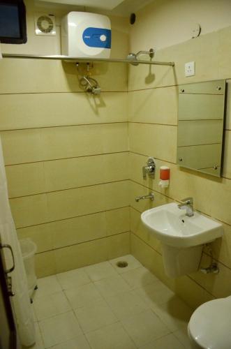 a bathroom with a sink and a mirror at Hotel 49 in Amritsar