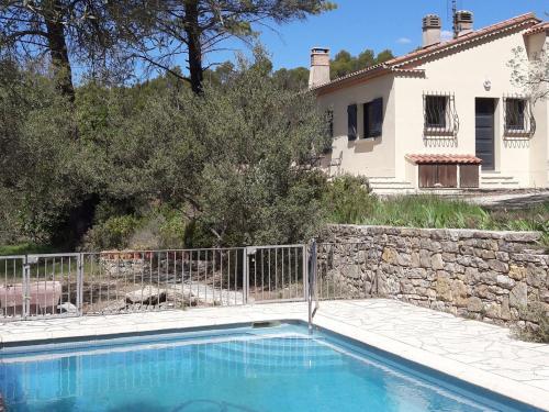 a villa with a swimming pool in front of a house at Elegant holiday home with private pool in Masseboeuf