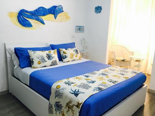 a bedroom with a blue and white bed with pillows at I 4 Elementi in Naples