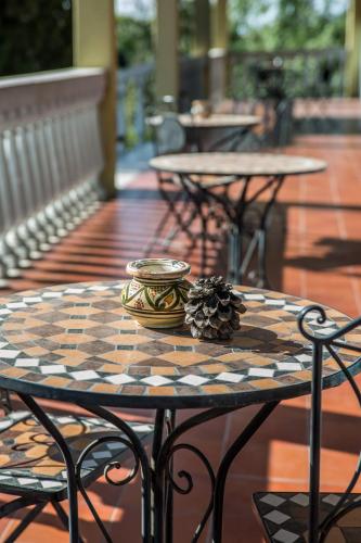 a table with a pineapple on it on a patio at Hotel Il Lato Azzurro - Isola di Sant'Erasmo - NO VEHICLES ACCESS in Venice