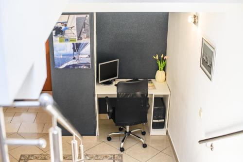 an office with a desk with a computer and a chair at Villa Jidro in Trogir