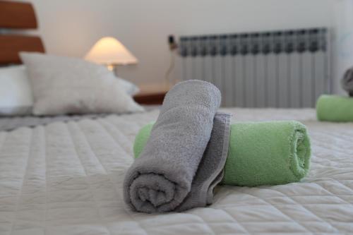 a rolled up towel on top of a bed at Apartments Mare in Brela