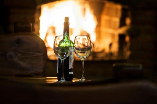 a bottle of wine and two glasses on a table at Hotel Biathlon Sport & Spa in Szklarska Poręba