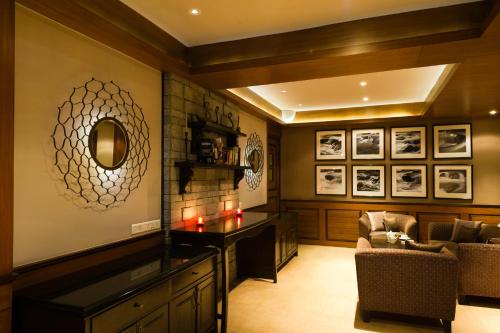 a living room with a table and a chair at The Vintage Gulmarg in Gulmarg