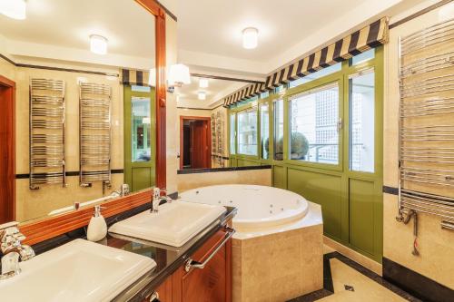 a bathroom with two sinks and a tub at Grand Apartments - Blue Marlin - Luxury Apartments in Sopot