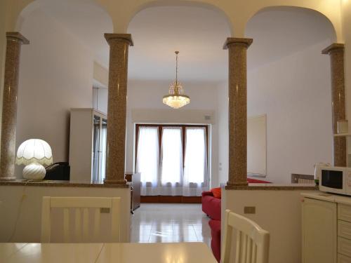 a living room with a kitchen and a dining room at L'Antico Borgo in Lesa