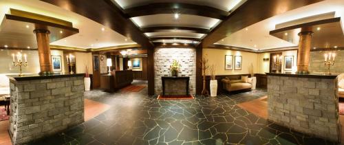 a lobby with a fireplace and a brick wall at The Vintage Gulmarg in Gulmarg