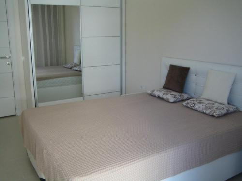 a bedroom with a bed with a large mirror at Emerald Towers Residence in Avsallar