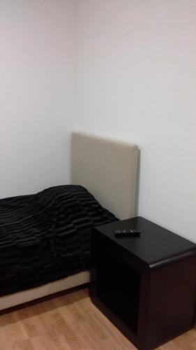 a bedroom with a black bed and a table at Casal da Porta - Quinta da Porta in Mirandela