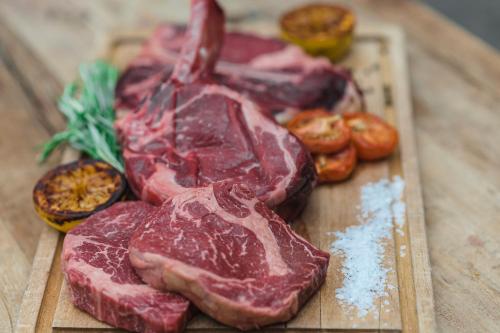 a bunch of cuts of meat on a cutting board at Best Western Hotel Norrkoping City in Norrköping