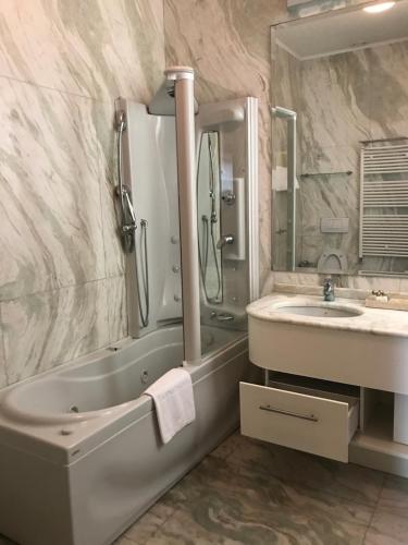
a bathroom with a sink, toilet and bathtub at Foscari Palace in Venice
